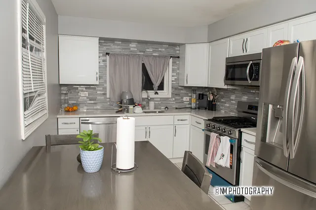 a kitchen with a sink a stove and cabinets