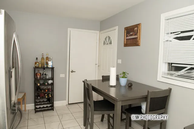 a view of a dining room with furniture and window