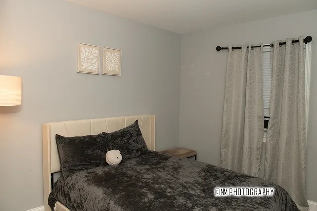 a bedroom with a bed and a window