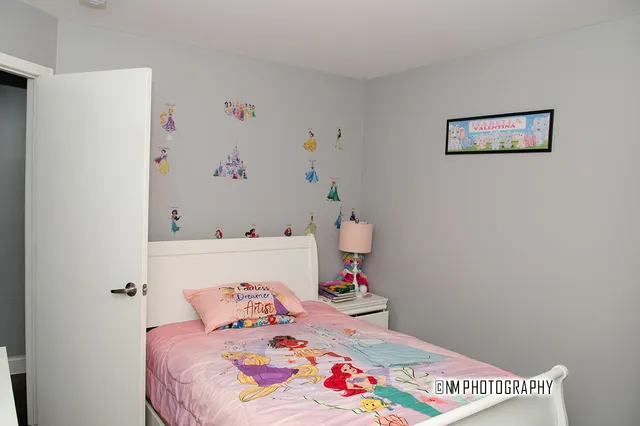 a bedroom with a bed and a dresser