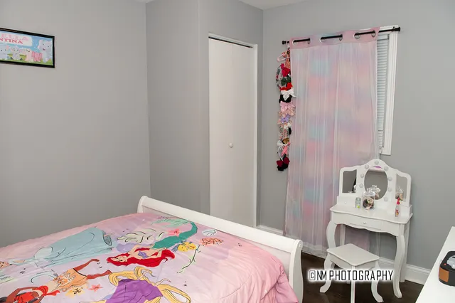 a bedroom that has a bed and a window in it