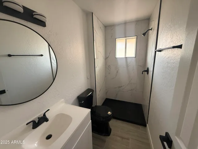 a bathroom with a sink a toilet and a mirror