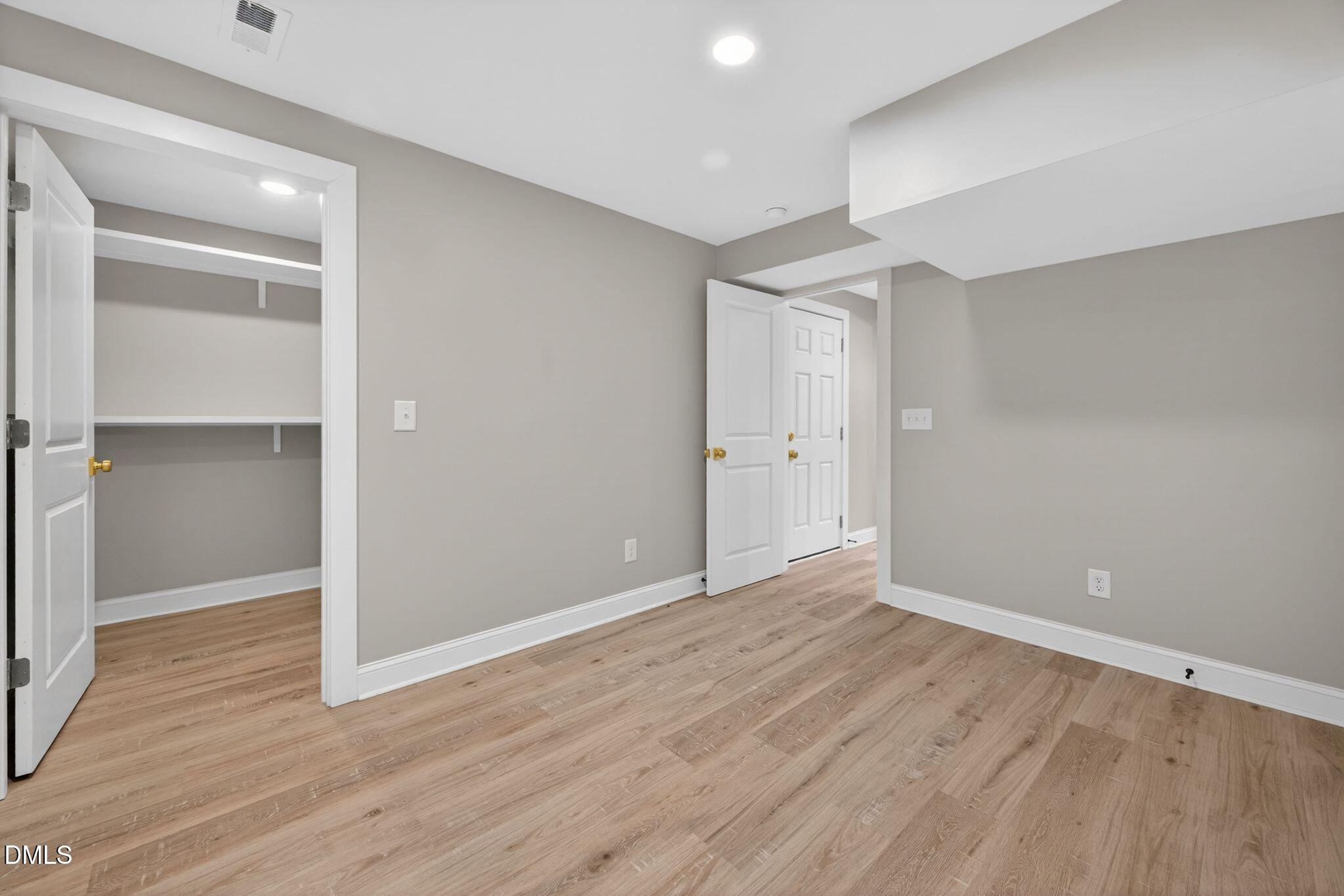 313 Crown Oaks Drive Raleigh, NC 27615 - Photo 30 of 60 a view of an empty room with wooden floor