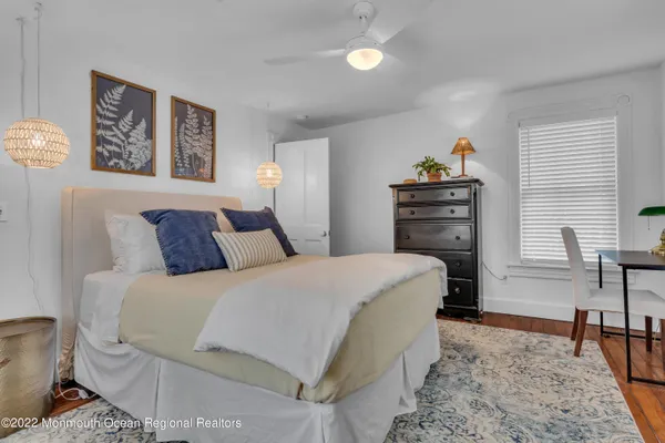 a bedroom with a bed and a couch
