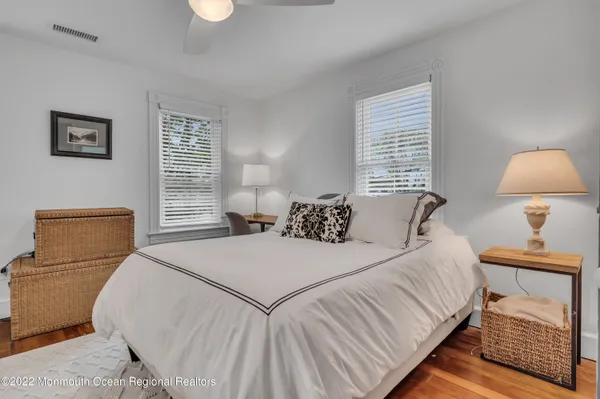 a bedroom with a bed and a lamp on table