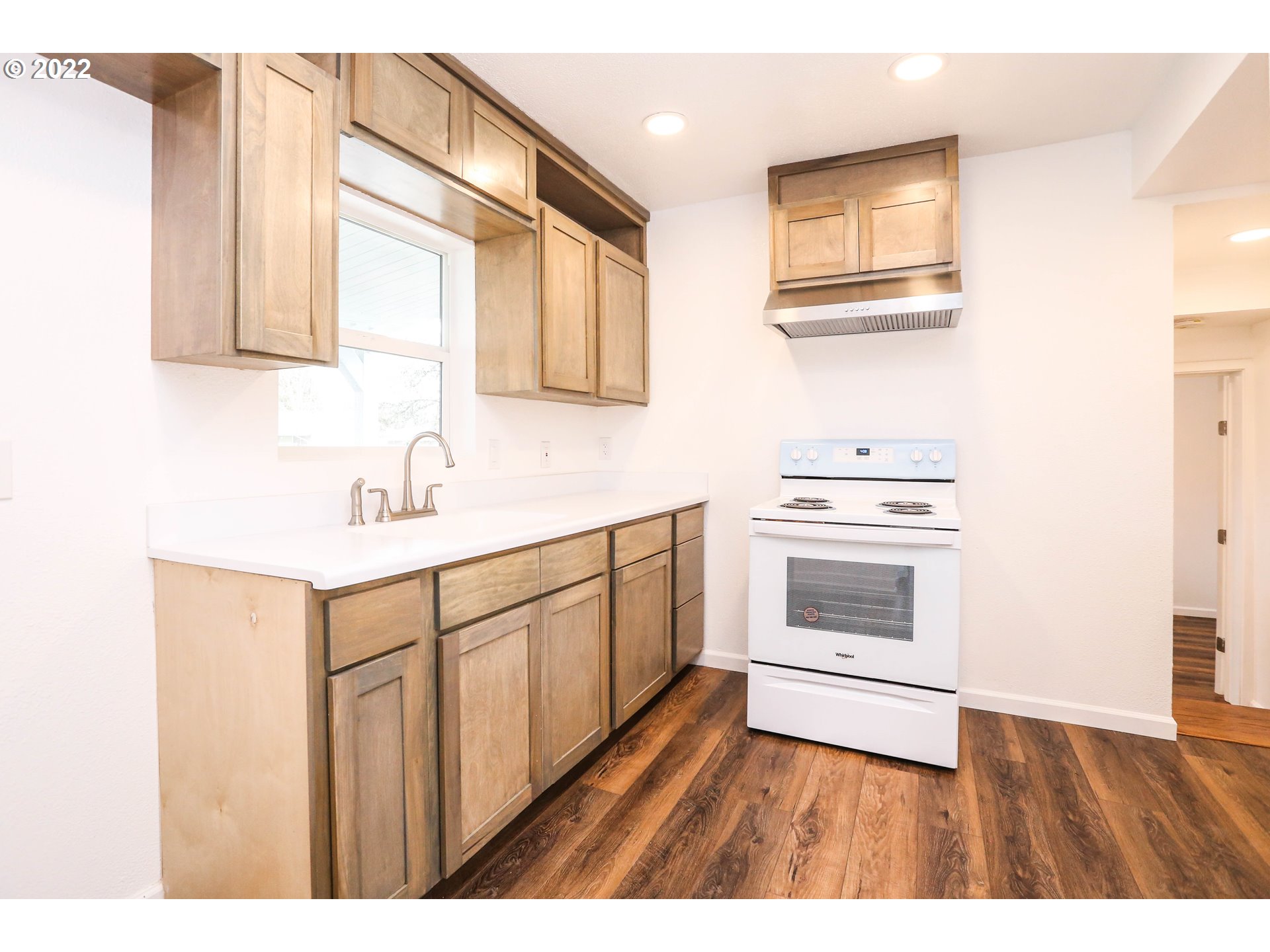 625 West Fairview Drive Springfield, OR 97477 - Photo 3 of 24 a kitchen with cabinets wooden floor and stainless steel appliances