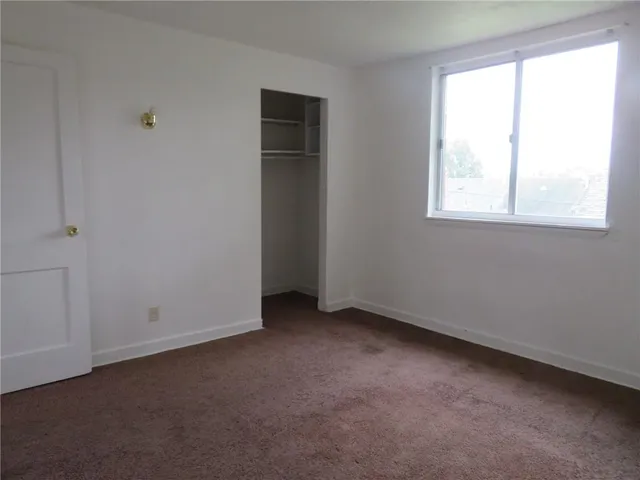 an empty room with a empty space and a window