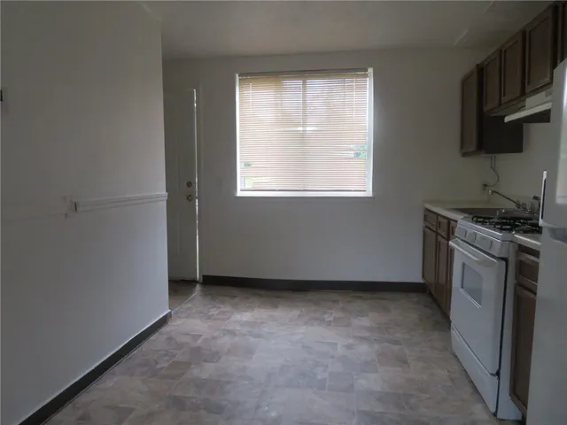 a view of a kitchen with a stove top oven a sink and dishwasher