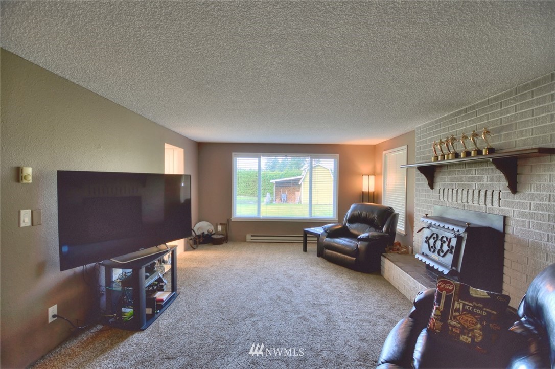18233 Melon Court Southwest Rochester, WA 98579 - Photo 5 of 25 a living room with furniture and a flat screen tv