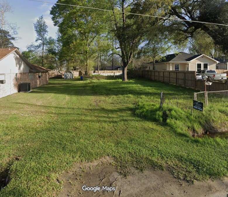 Cleared lot with new fence on two sides