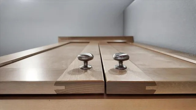 a kitchen with a refrigerator a sink and wooden floor