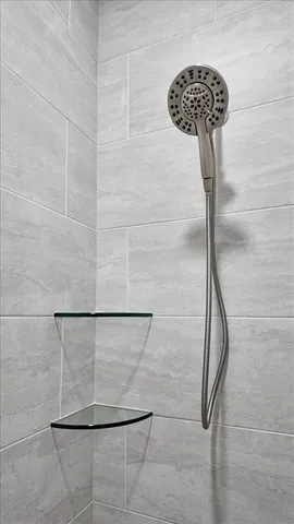 en empty room with windows and fan