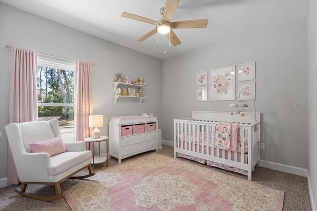 an empty room with a ceiling fan and a window