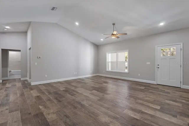 wooden floor in an empty room with a window