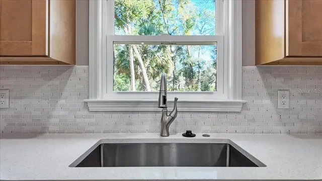 a kitchen with a sink a stove and microwave
