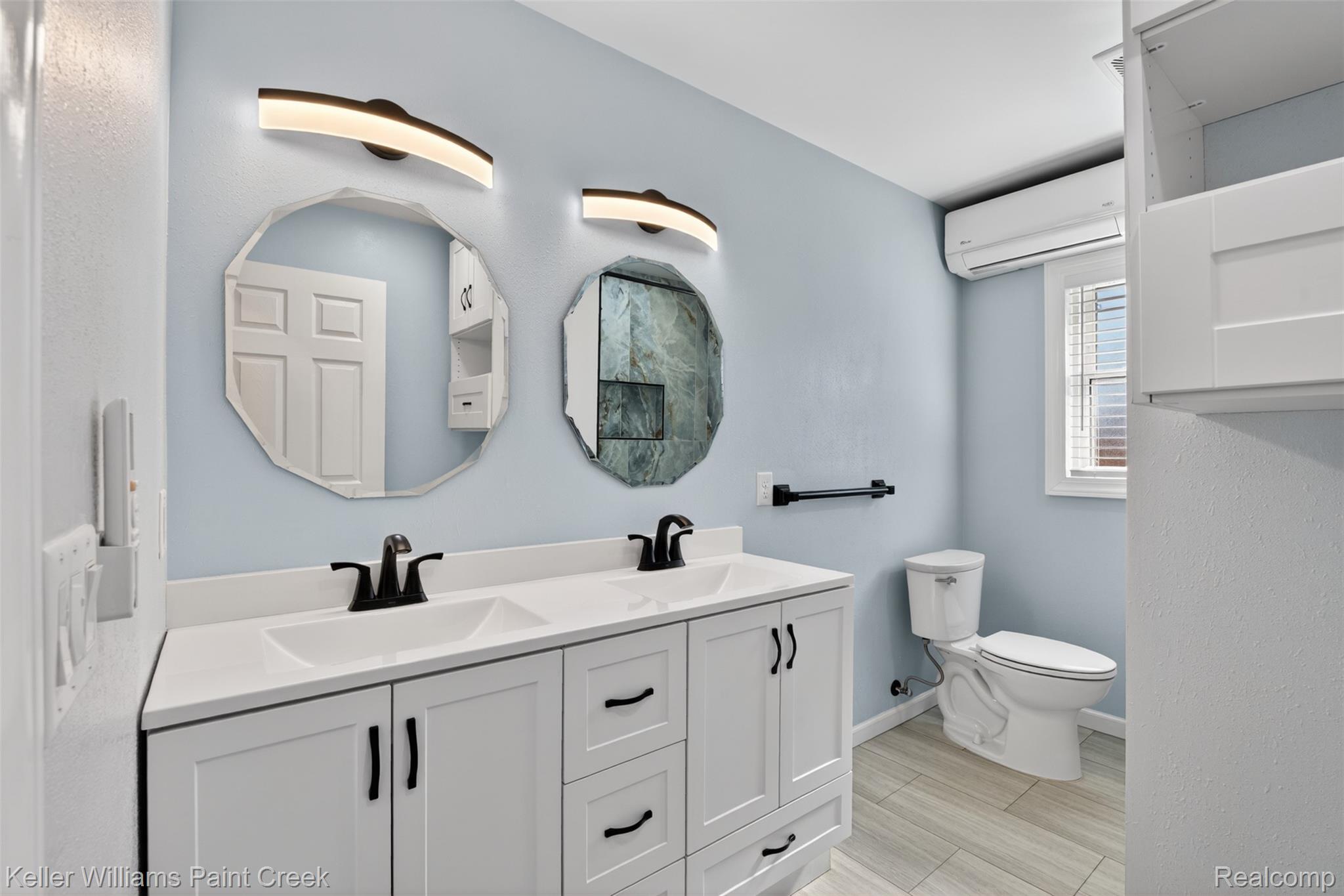 2942 Tatham Road Saginaw, MI 48601 - Photo 17 of 59 Full bath with double vanity and a mini split for heating / cooling