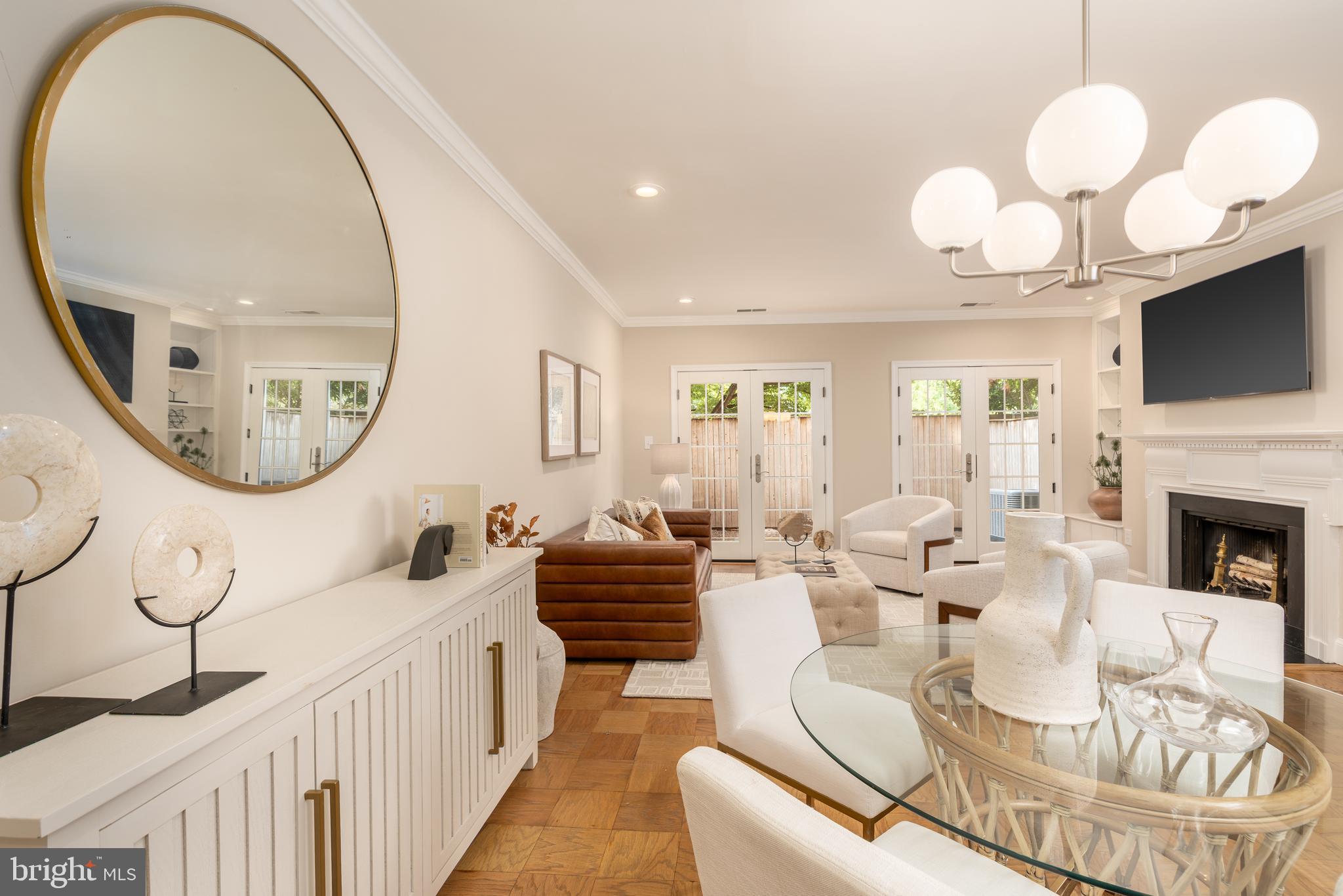 3299 Sutton Place Northwest, Unit C Washington, DC 20016 - Photo 15 of 40 a living room with furniture a large window and a fireplace