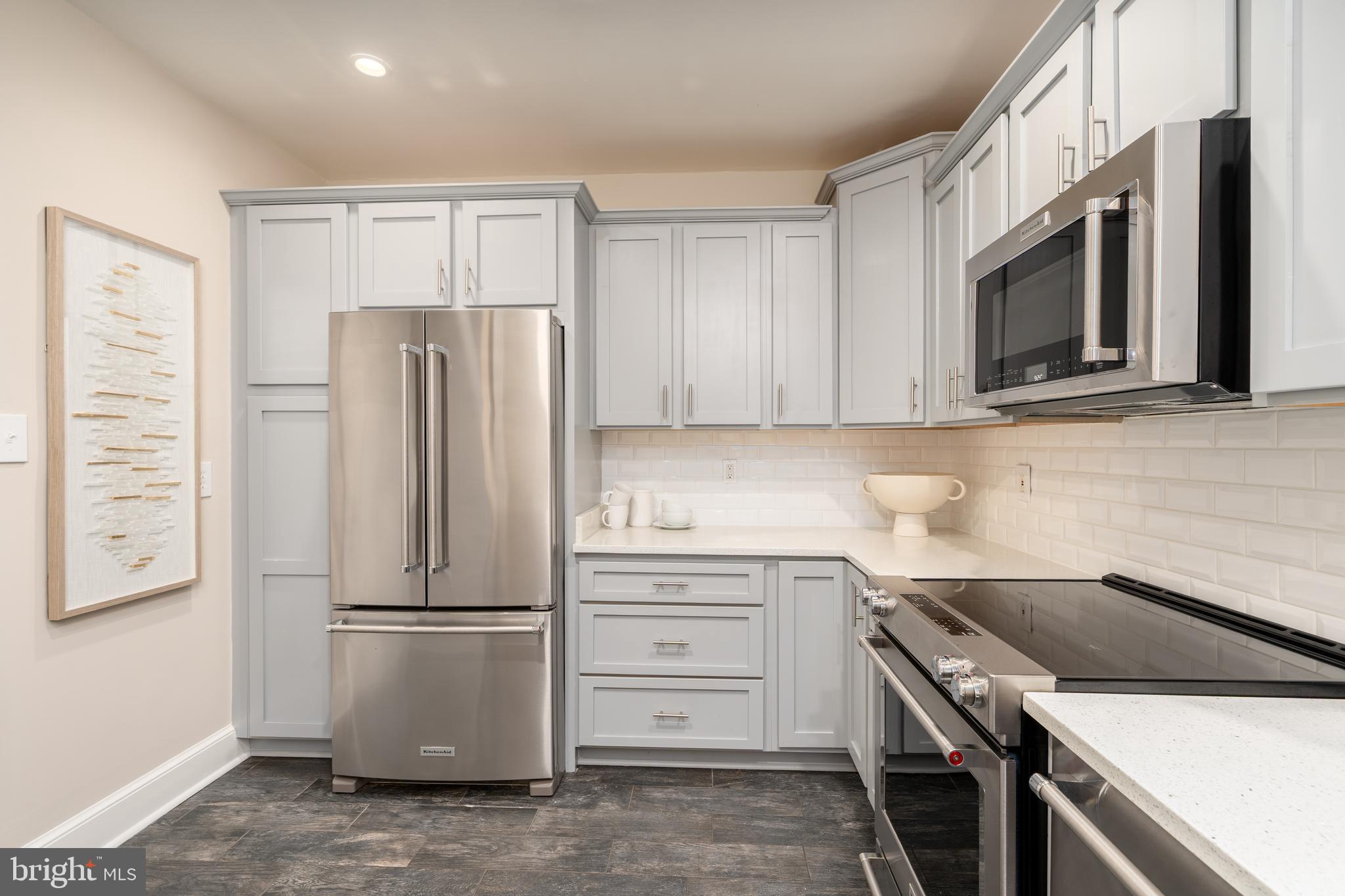 3299 Sutton Place Northwest, Unit C Washington, DC 20016 - Photo 16 of 40 a kitchen with a refrigerator stove and microwave