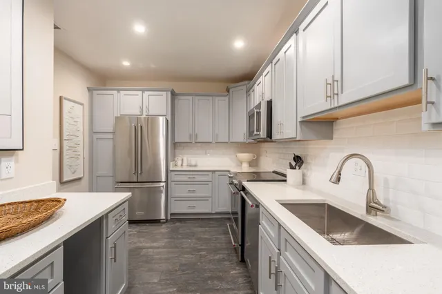 a kitchen with a sink cabinets and a wooden floor