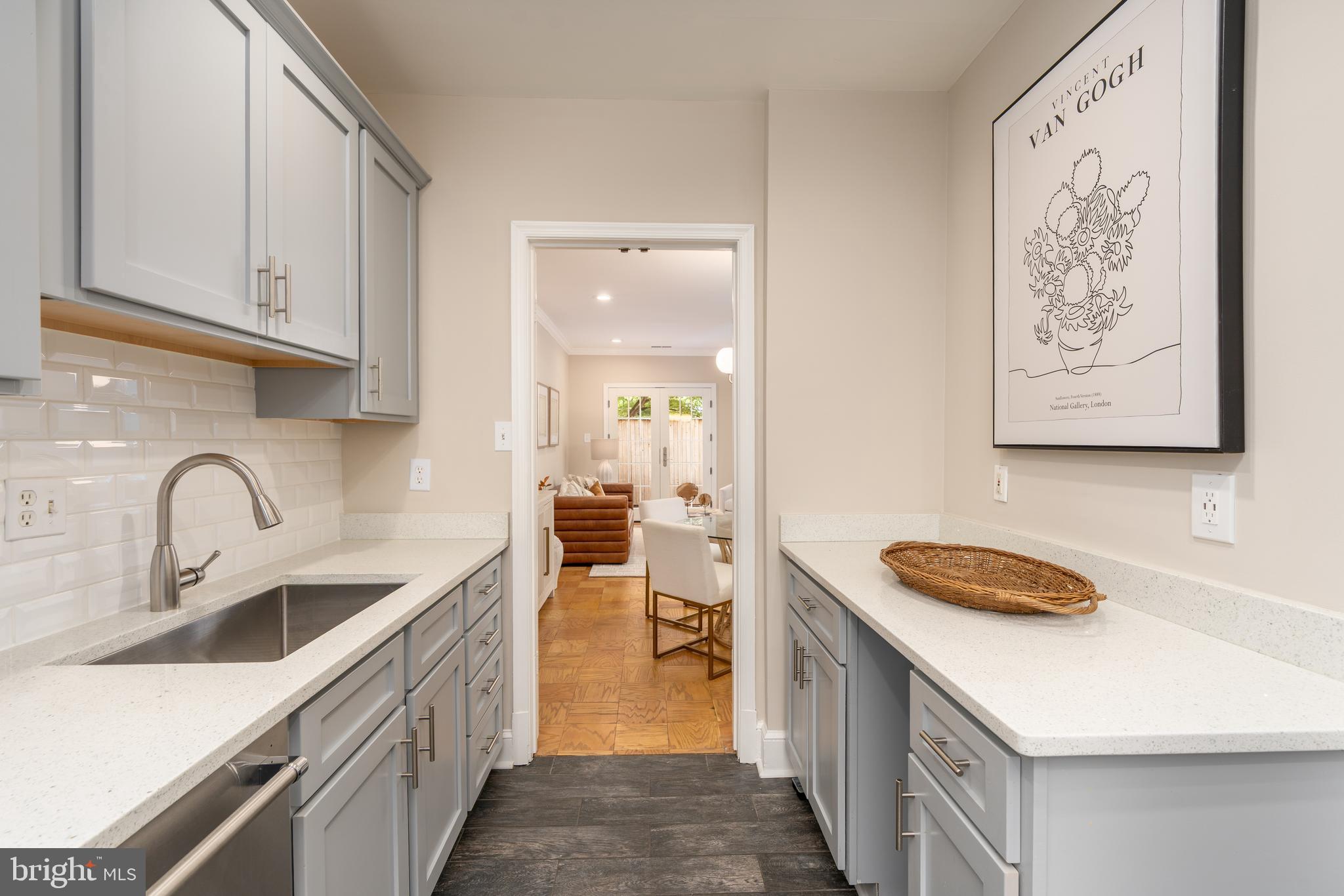 3299 Sutton Place Northwest, Unit C Washington, DC 20016 - Photo 19 of 40 a kitchen with a sink cabinets and a wooden floor