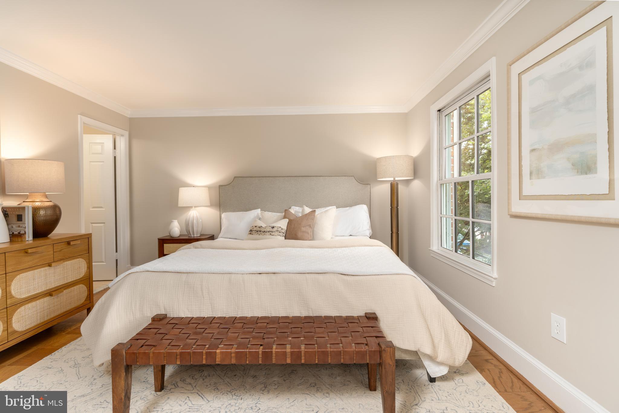 3299 Sutton Place Northwest, Unit C Washington, DC 20016 - Photo 23 of 40 a bedroom with a bed and wooden floor