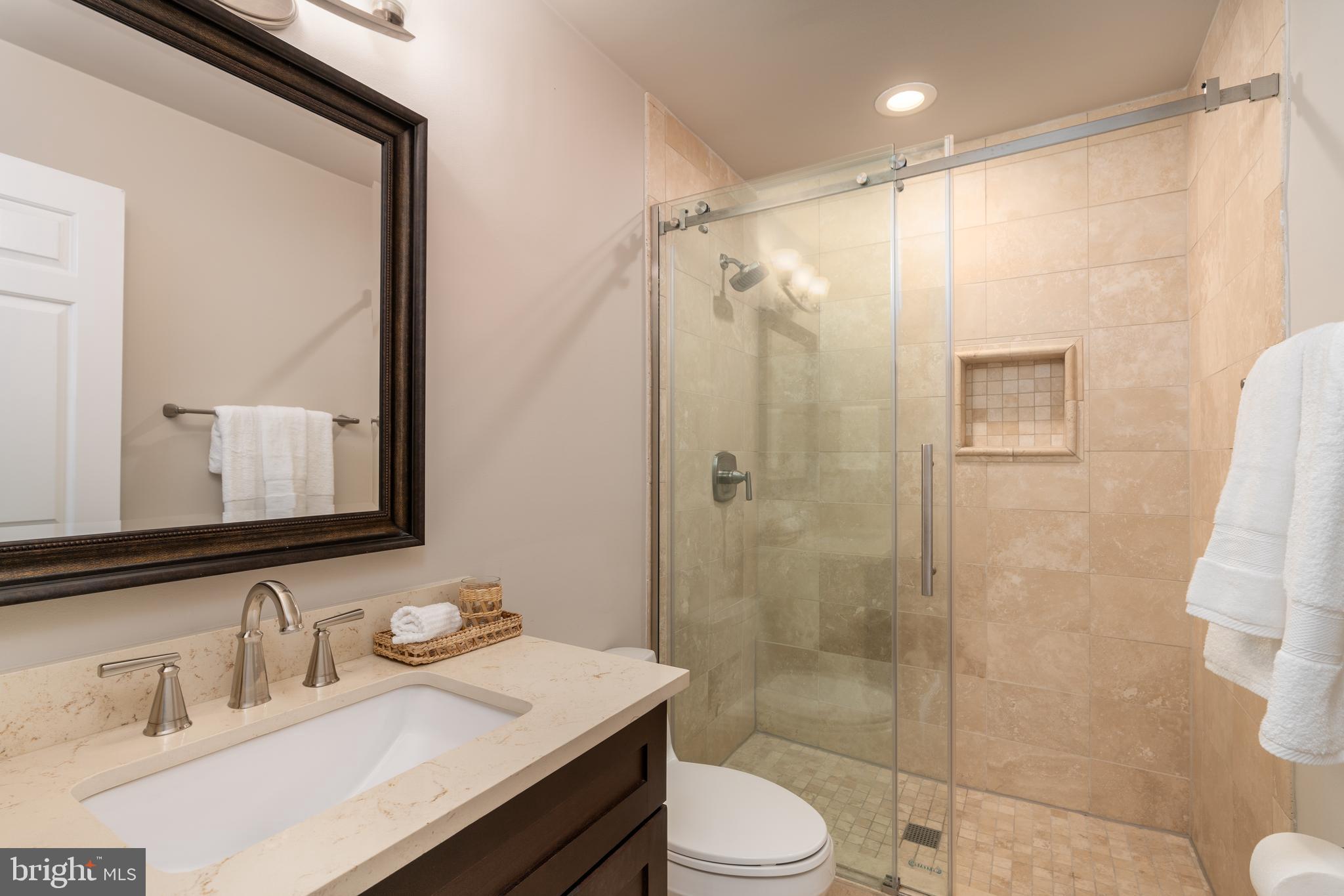 3299 Sutton Place Northwest, Unit C Washington, DC 20016 - Photo 26 of 40 a bathroom with a sink a toilet and shower