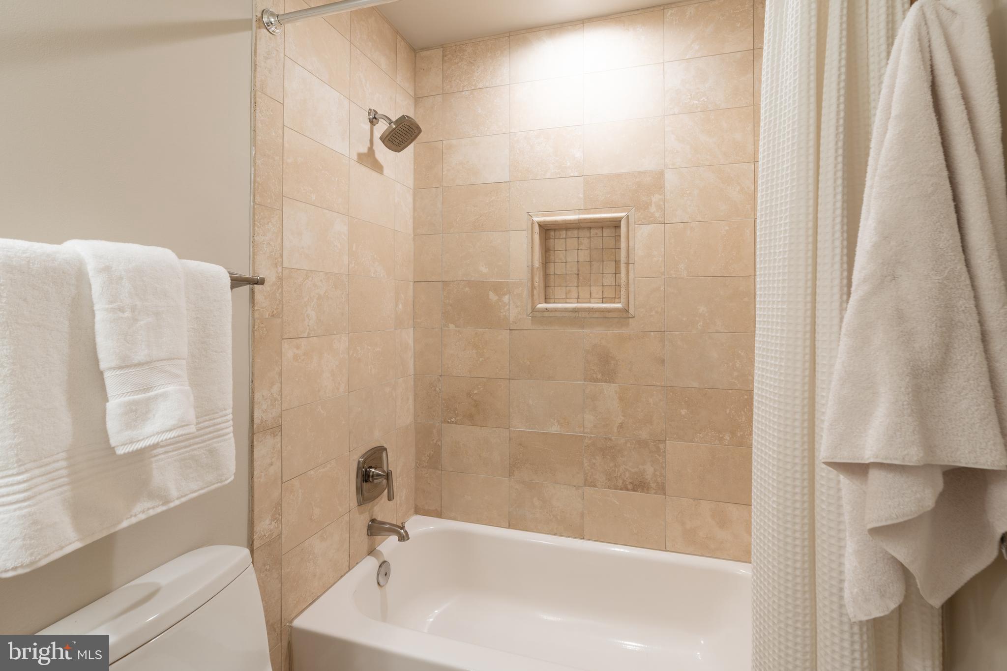 3299 Sutton Place Northwest, Unit C Washington, DC 20016 - Photo 30 of 40 a bathroom with a tub