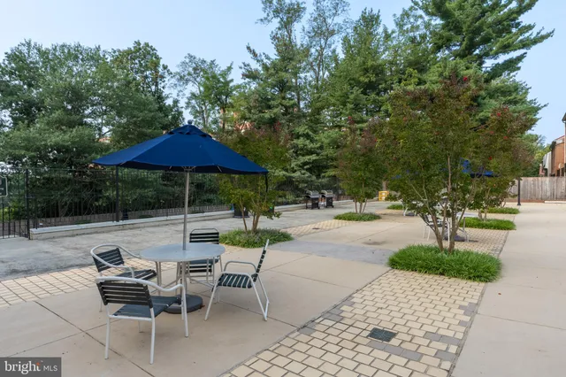 an outdoor space with patio and white umbrellas