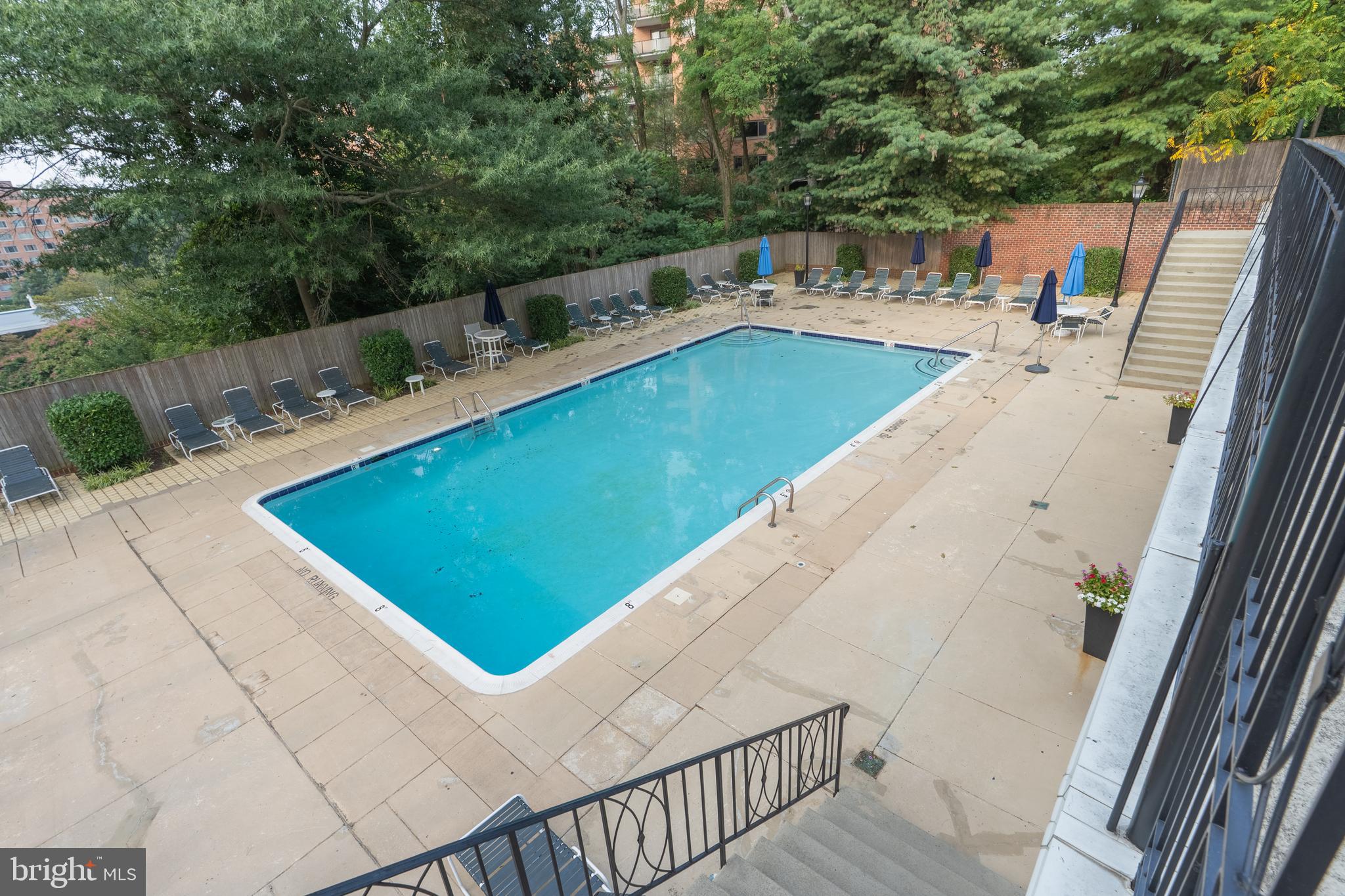 3299 Sutton Place Northwest, Unit C Washington, DC 20016 - Photo 36 of 40 a view of a swimming pool with lounge chair
