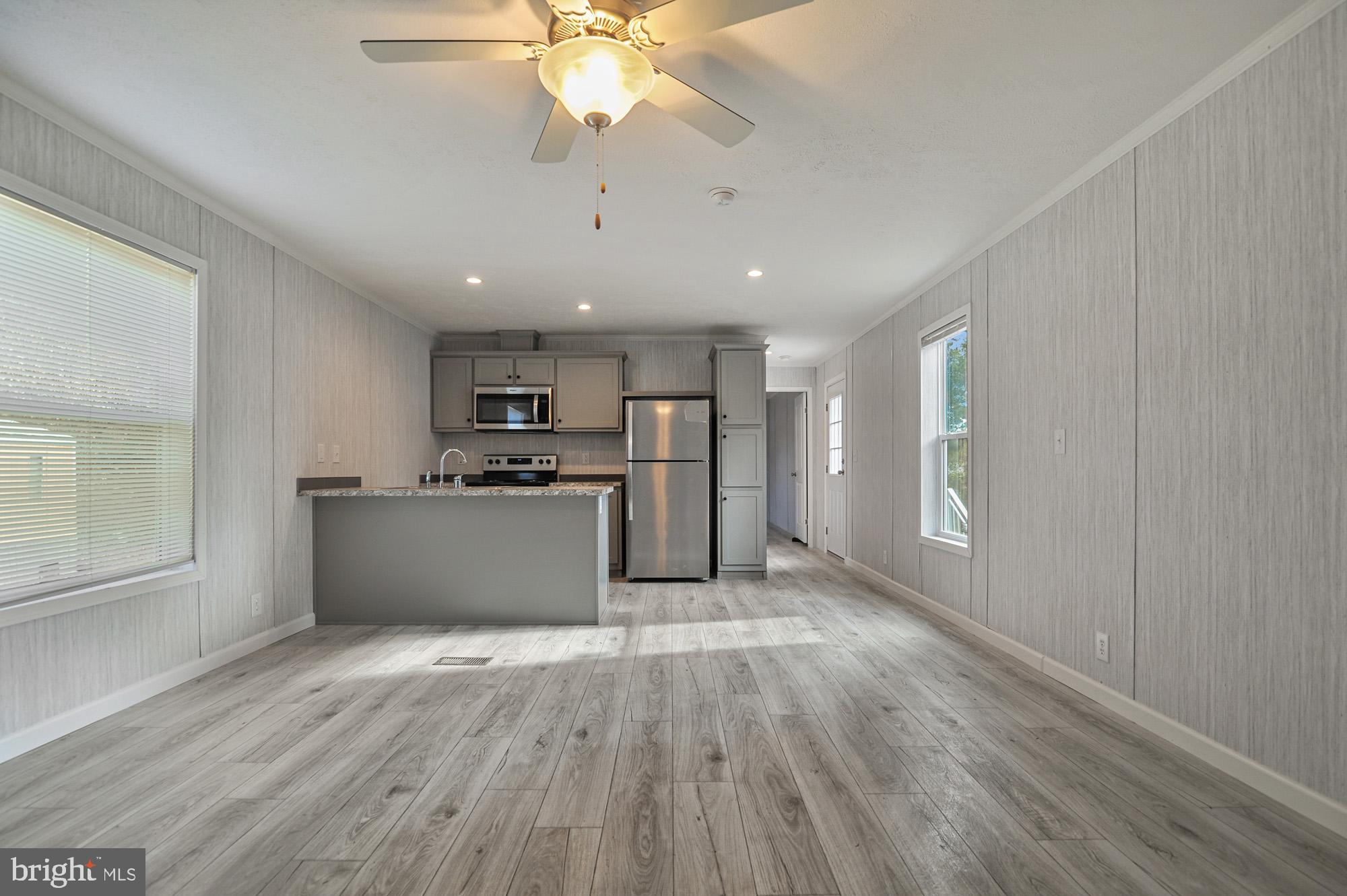 1061 South Little Creek Road, Unit 207 Dover, DE 19901 - Photo 1 of 20 a view of kitchen with stainless steel appliances refrigerator stove and wooden floor