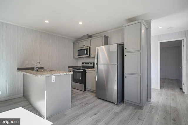 a kitchen with a refrigerator sink and microwave