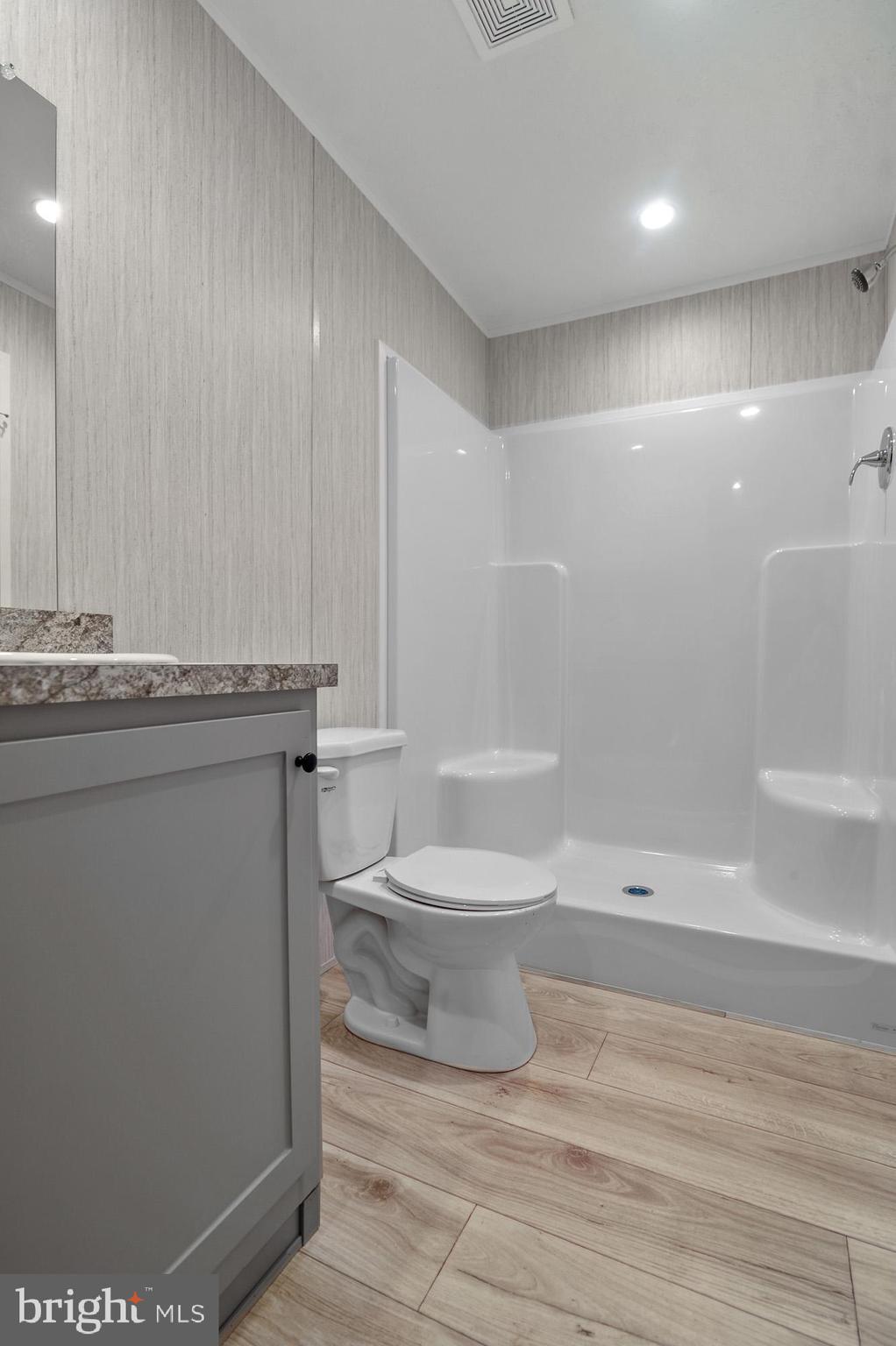 1061 South Little Creek Road, Unit 207 Dover, DE 19901 - Photo 16 of 20 a white toilet sitting next to a bathroom sink