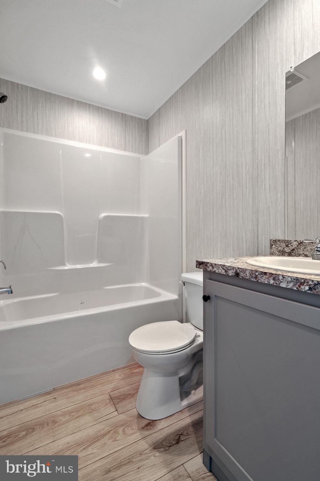 1061 South Little Creek Road, Unit 207 Dover, DE 19901 - Photo 17 of 20 a bathroom with a sink a toilet and a bathtub