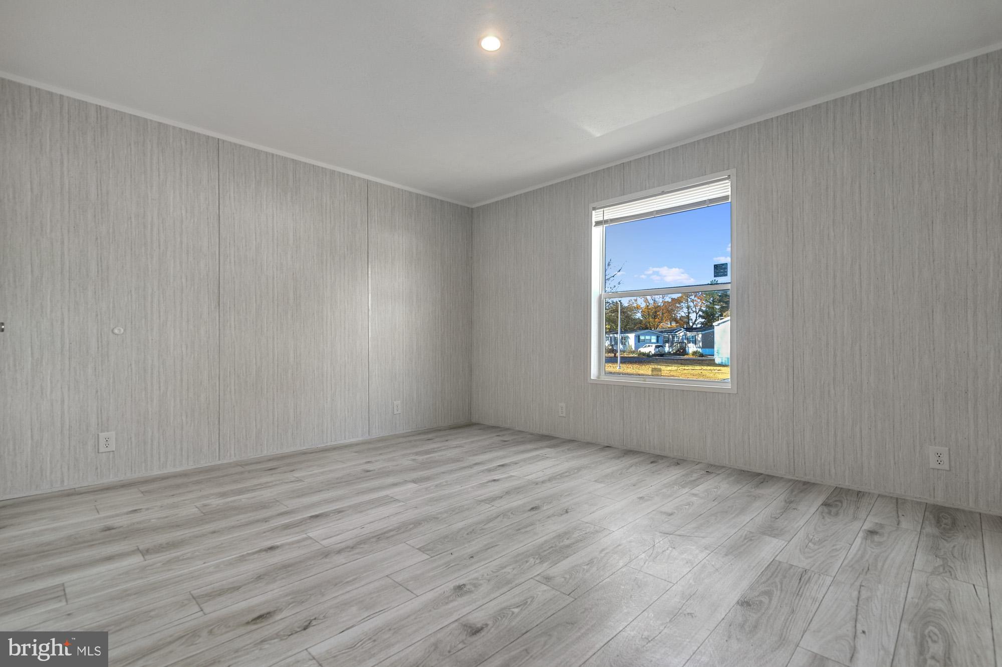 1061 South Little Creek Road, Unit 207 Dover, DE 19901 - Photo 18 of 20 an empty room with wooden floor and windows