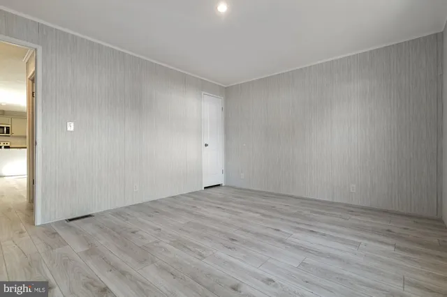 a view of an empty room and wooden floor