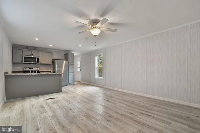 a view of kitchen with wooden floor and window