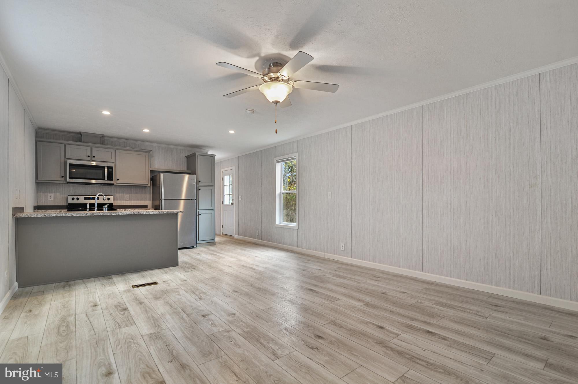 1061 South Little Creek Road, Unit 207 Dover, DE 19901 - Photo 6 of 20 a view of kitchen with wooden floor and window