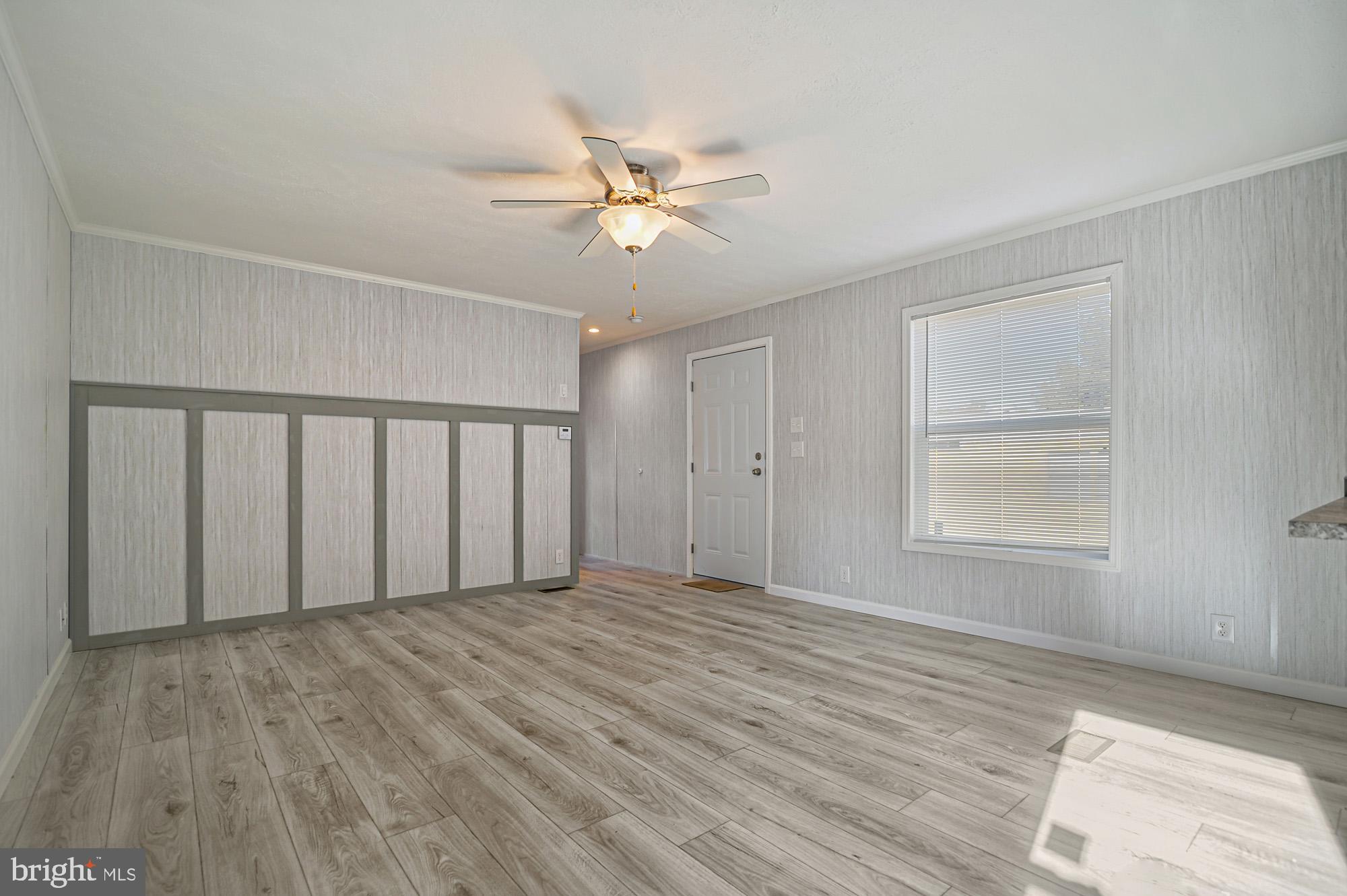 1061 South Little Creek Road, Unit 207 Dover, DE 19901 - Photo 9 of 20 a view of an empty room with wooden floor and a window