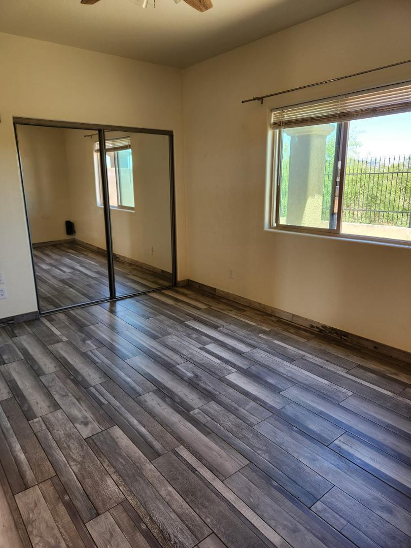 3641 Camino Del Rancho Douglas, AZ 85607 - Photo 10 of 20 a view of an empty room with wooden floor and a window