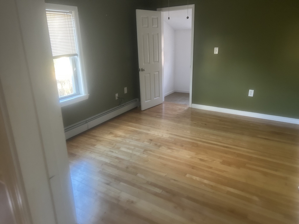 3 Julien Avenue Worcester, MA 01604 - Photo 6 of 8 an empty room with wooden floor and windows