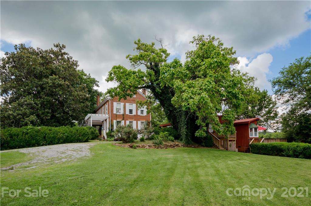 3379 Polk County Line Road Rutherfordton, NC 28139 - Photo 3 of 36 a front view of a house with a yard and a tree