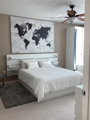 a bedroom with a bed and wall painting