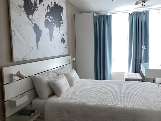 a bedroom with a bed and a window