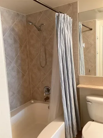 a bathroom with a tub and shower