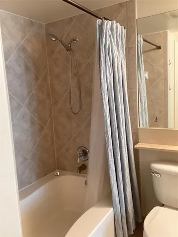 a bathroom with a tub and shower