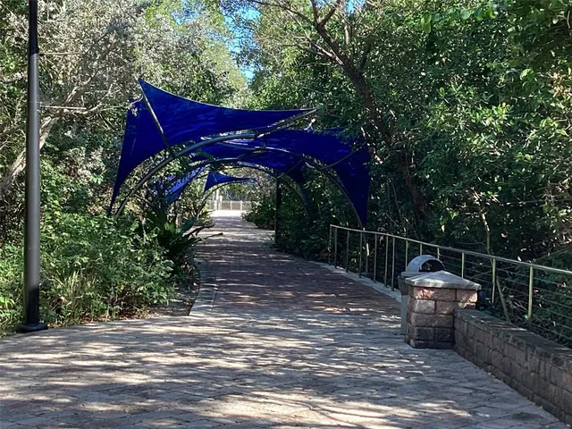 a roof deck with table and chairs and potted plants