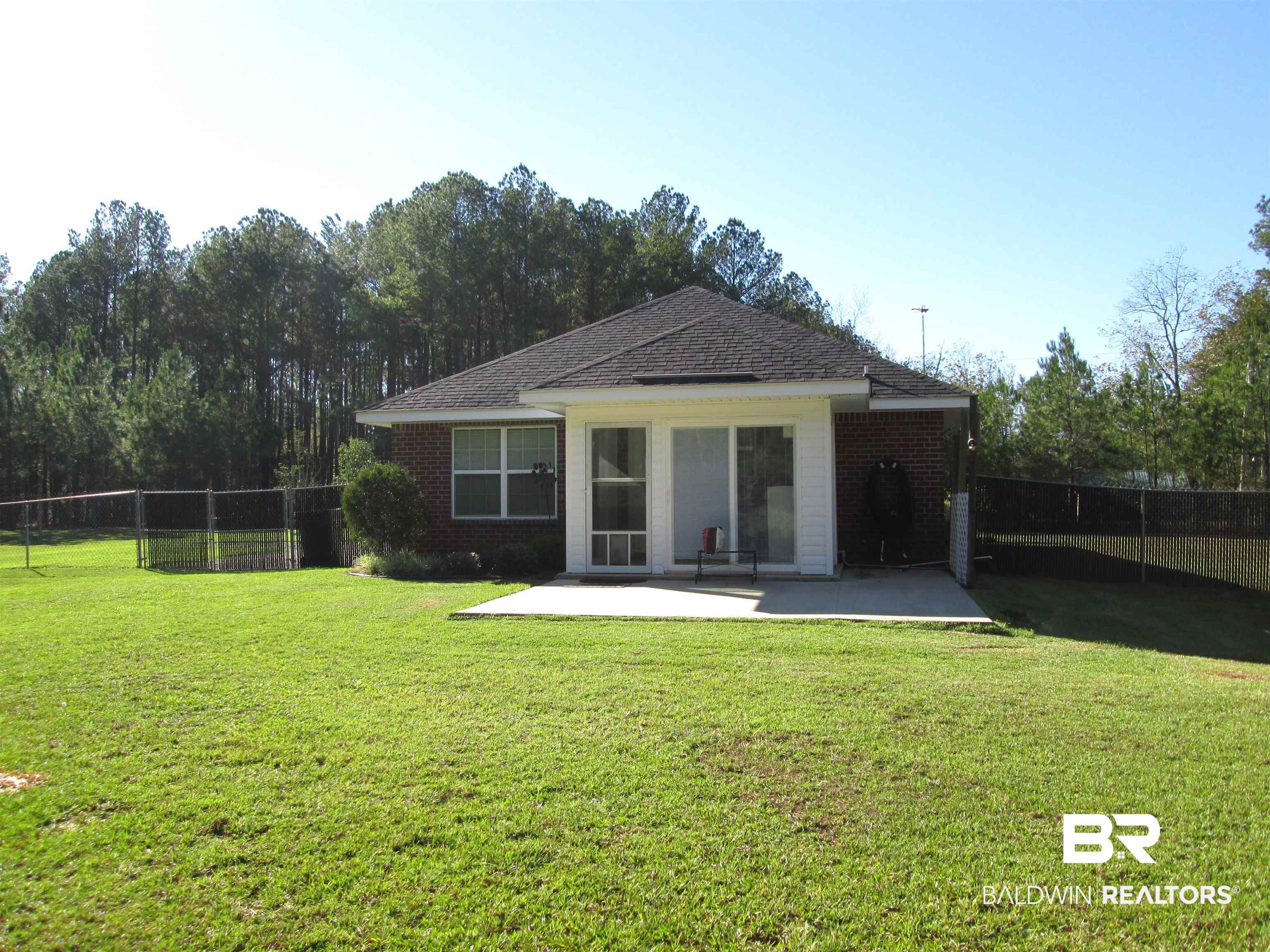 530 Brethren Church Road Fruitdale, AL 36539 - Photo 17 of 24 Rear view of house featuring a patio area and a yard
