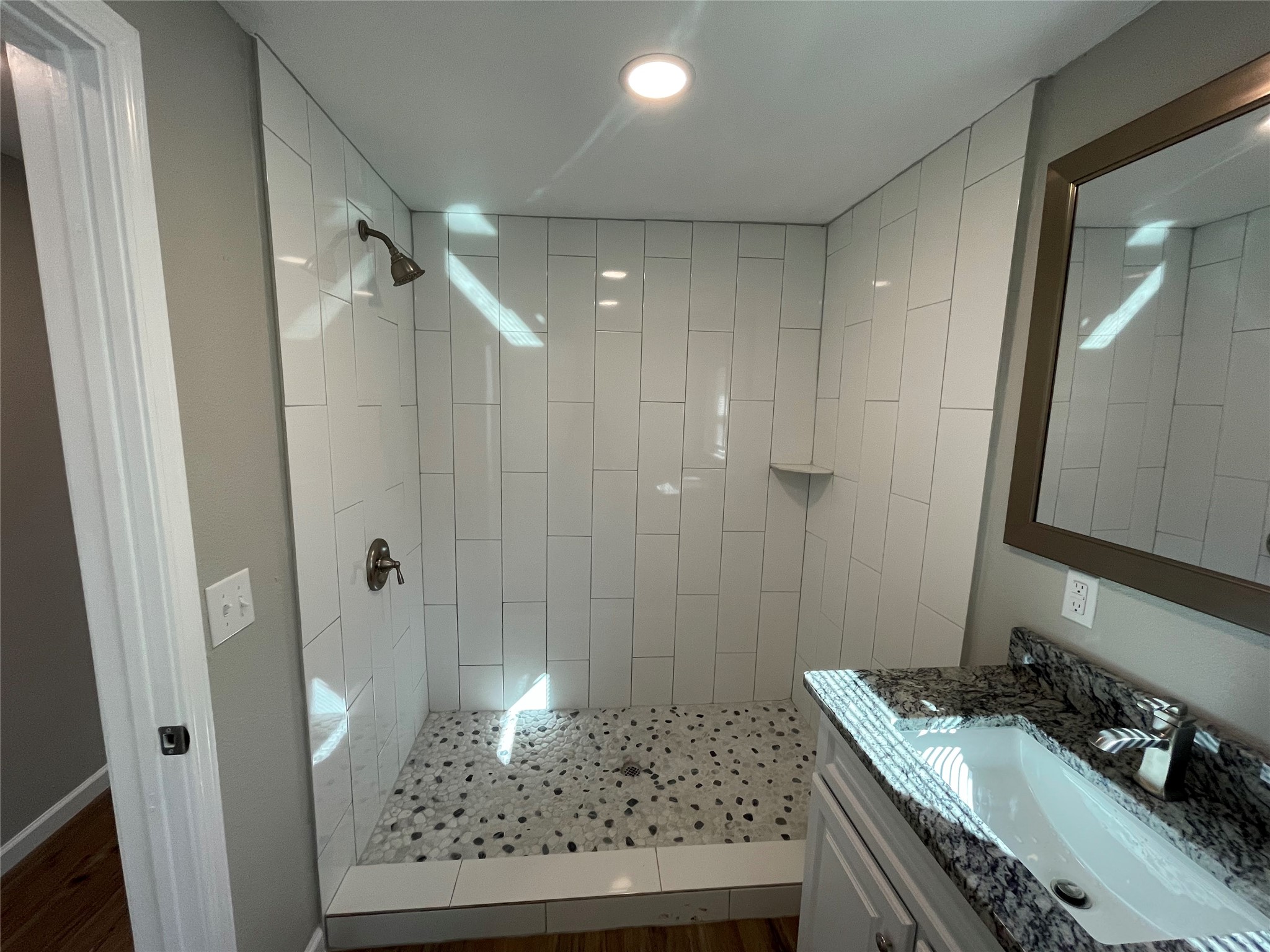 809 South Pierce Street Burnet, TX 78611 - Photo 3 of 7 Bathroom with a stall shower, vanity, and wood finished floors
