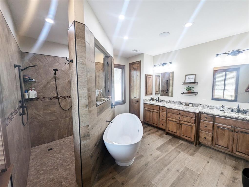 710 Albee Road West Nokomis, FL 34275 - Photo 20 of 30 a bathroom with a granite countertop sink toilet a mirror and shower