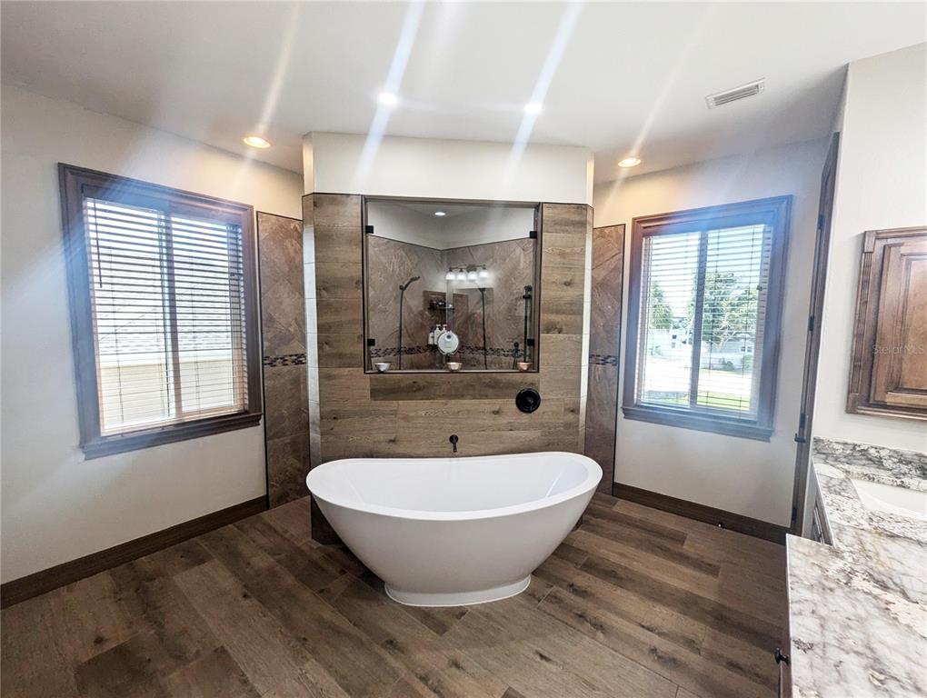 710 Albee Road West Nokomis, FL 34275 - Photo 21 of 30 a view of an empty room with wooden floor and a window